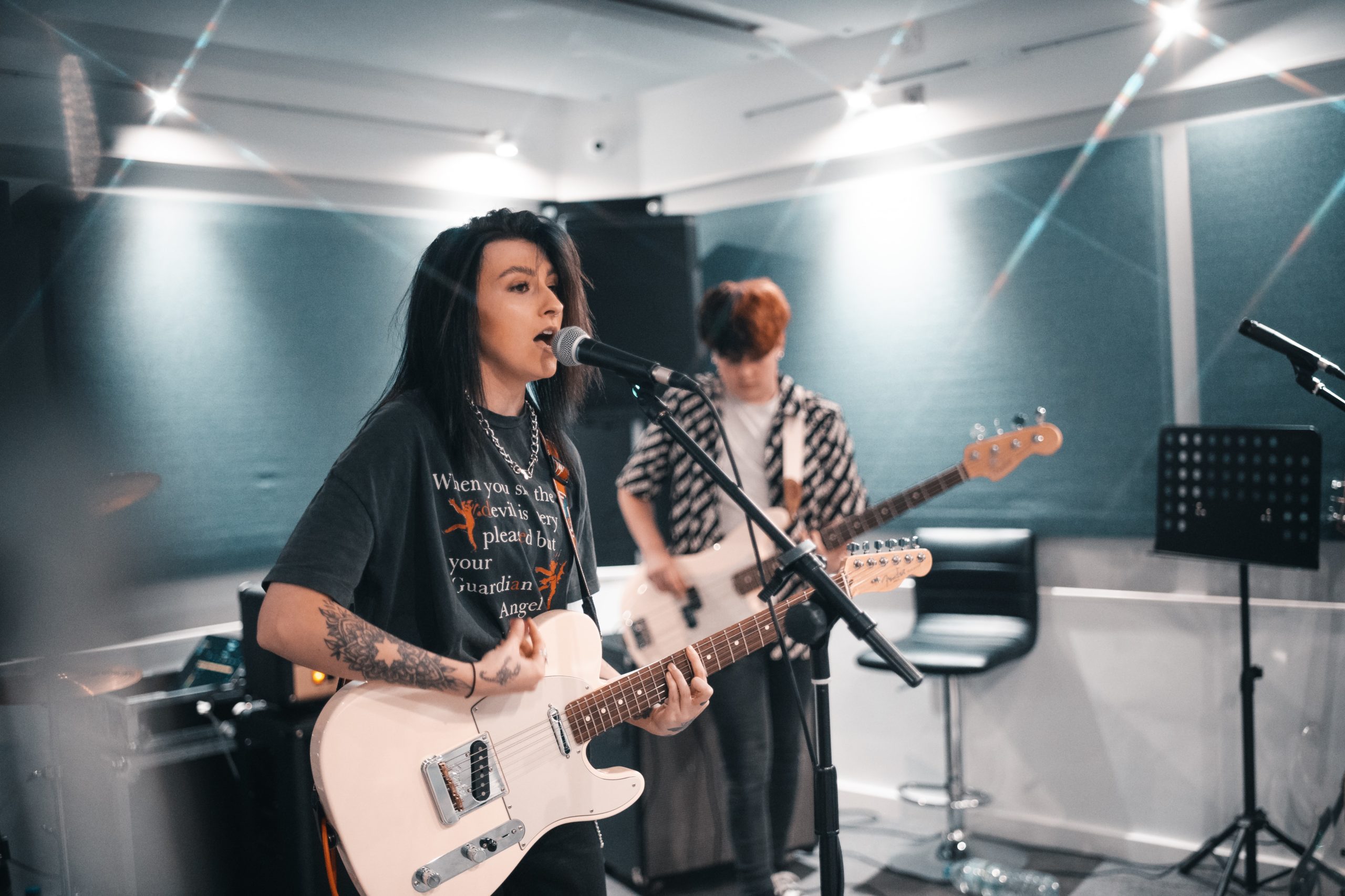 Band with lead singer at band rehearsal.